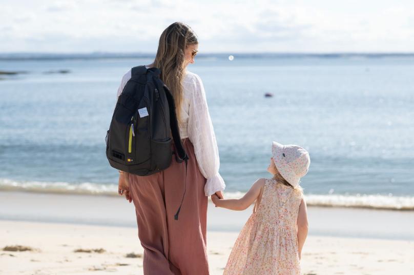 Leah and her daughter on the beach with the Dyson Air Quality backpack